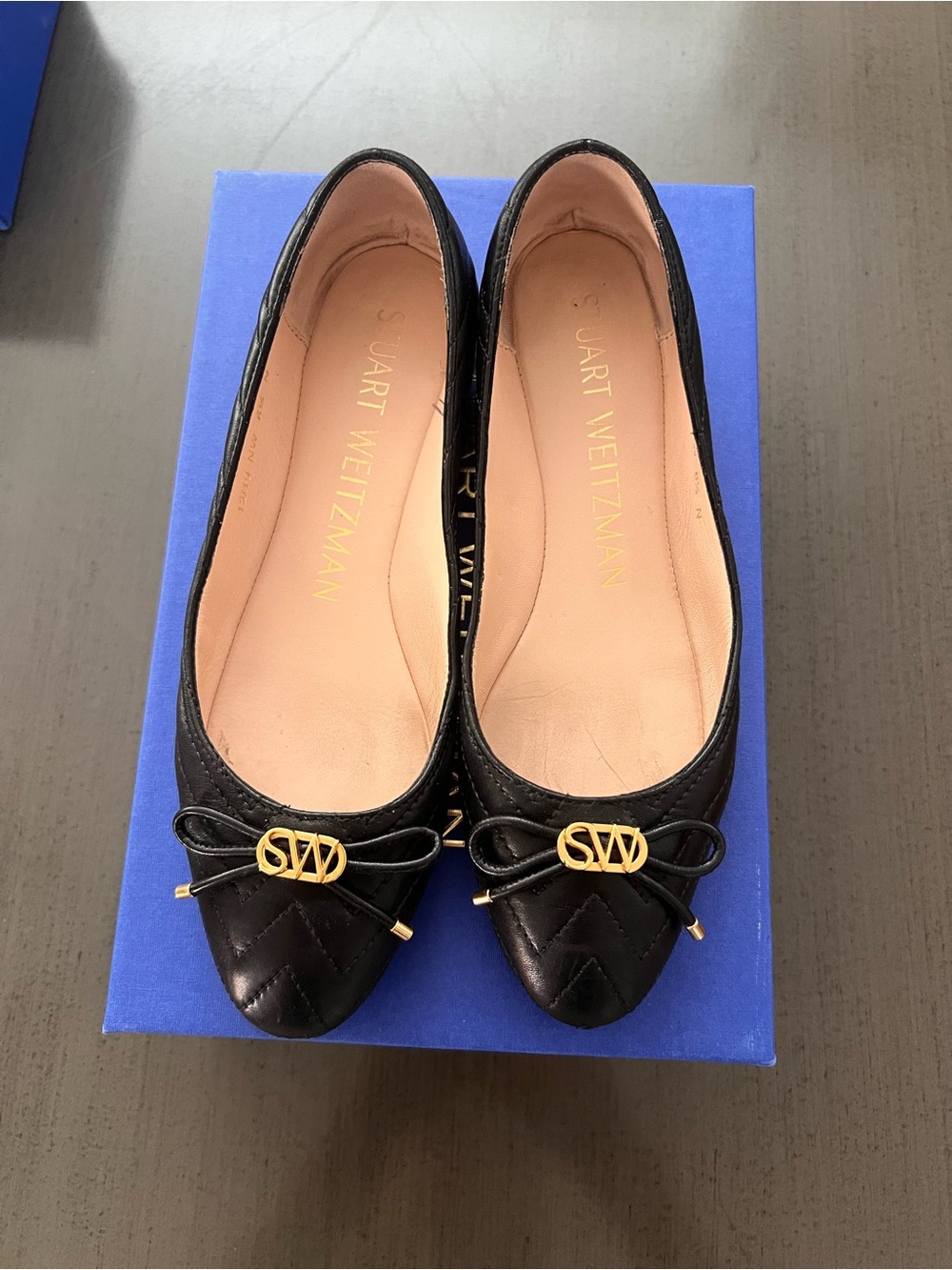 Stuart Weitzman Black Quilted Leather Pointed-Toe Flats with Gold Logo Bow